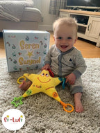 Seren Swynol Star-shaped Welsh toy that sings five welsh songs.Seren Swynol toy with baby boy.